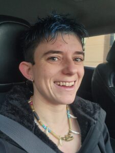 A photo of the author behind the Yip & Howl that leads to the "about" page of the author.
