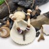 Shark carved from fossil shark tooth on a necklace with shell, wood, and bone beads.