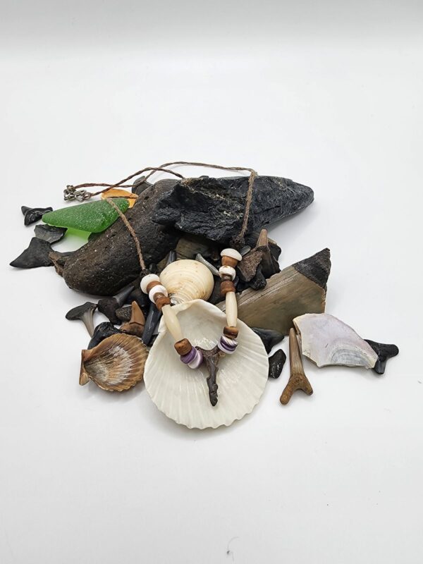 Shark carved from fossil shark tooth on a necklace with shell, wood, and bone beads.